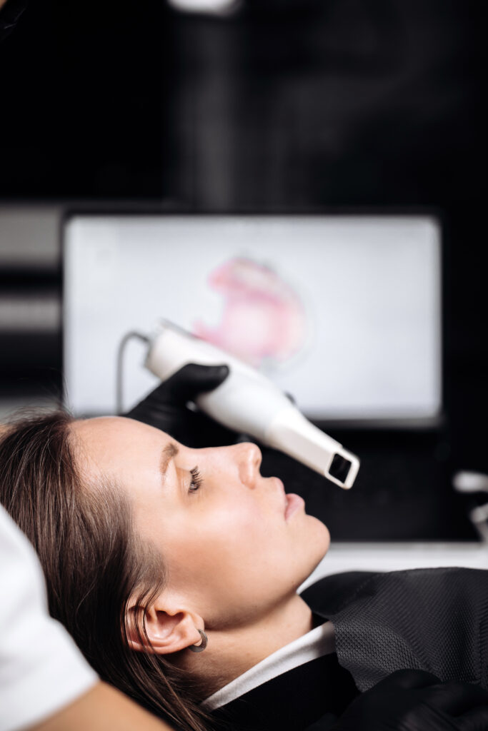 Conceptual dental technology, 3D scanning. A dentist performs a 3D scan of the oral cavity using an intraoral scanner in a modern dental clinic.